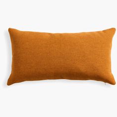 an orange pillow on a white background