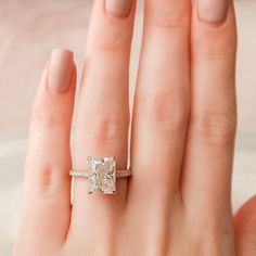 a woman's hand with a diamond ring on it