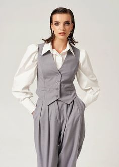 An essential piece that cannot be missing from a cool girl's fall wardrobe is a tailored vest. Easy to style it down with some jeans and sneakers or dress it up with our matching London Pants and London Blazer. Be bold and unbeatable in and out of meetings! four buttons at the front fitted style fully lined For an oversized look size it up!80%pl 20%viBust size: XS 89 cm // S 93 cm // M 97 cm // L 101 cm Waist size: XS 77 cm // S 81 cm // M 85 cm // L 89 cm Length: XS 54.5 cm // S 55.5 cm // M 56 Classic Vest For Workwear In Fall, Classic Vest For Work In Fall, Tailored Vest For Fall Workwear, Classic Workwear Vest For Fall, Classic Gray Vest For Work, Fitted Gray Vest For Workwear, Trendy Spring Vest For Workwear, Casual Office Vest For Winter, Trendy Spring Workwear Vest