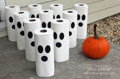 a bunch of toilet paper sitting on the ground next to a pumpkin