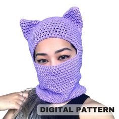 a woman wearing a purple knitted cat mask