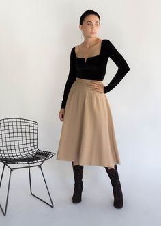 "Vintage 50s full wool skirt. This skirt is what vintage is about with its quality fabric and sweet details. High-waisted fit. Decorative dart waist. Below knee length. Voluminous full silhouette. Cut from a khaki quality wool fabric. Back hook and eye and zipper fastening. Fully lined. We kindly ask that you please view all measurements for comparison so you can get your desired fit. * Brand: n/a * Decade: 1950s * Fabric: Wool * Lining: Silk Crepe * Color: Kahki / Beige C O N D I T I O N Excell 1950s Fabric, Gold Cardigan, Dusty Pink Dresses, Knitted Cape, 90s Dress, Wool Skirt, Model Fits, Wool Skirts, Silhouette Cut