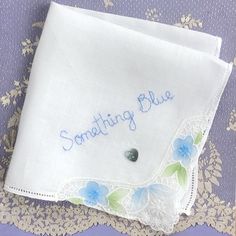 something blue embroidered on a white handkerchief