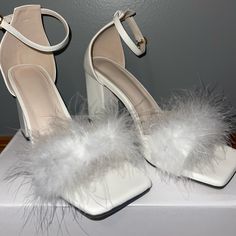 White Feather Heels. Perfect For Bridal Showers, Bachelorette Parties, Or For Adding Some Sass To Your Outfit! These Heels Are In Great Condition And Look Brand New. They Have A Unique Clasp That Makes Putting Them On And Taking Them Off Very Easy. They Were Only Worn Once. They Are A Size 38 Which Is Equal To Us Size 8. White Heels With Feathers, Feathered Heels With Round Toe For Summer, White Block Heels With Heel Strap For Party, Formal Open Toe Sandals With Feathers, Summer Heels With Feather Trim And Round Toe, Summer High Heel Feathers Heels, Feathered Heels With Round Toe, Summer High Heels With Feathers, Summer Evening Heels With Feathers