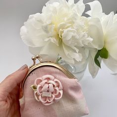 "Rose Gold Kisslock Coin Purse, also known as \"Gamaguchi\" in Japan.  Made with Pink/White \"Muddy Works\" pink light weight cotton canvas fabric and adorned with a Kanzashi peony flower, this compact purse is a stylish accessory. Its metal clasp closure provides easy access, while the beige/pink floral cotton lining adds a touch of elegance. Our Rose Gold Kisslock Coin Purse is a testament to impeccable craftsmanship and attention to detail. Its elegant design, combined with the traditional elements of Kanzashi, creates a unique and eye-catching piece.  It's perfect for your essentials. Elevate your style with this beautifully crafted coin purse. Finish size (approximate) 10cm (L) x 11cm (H) x 2cm (W)" Vintage Pink Wallet For Everyday, Handmade Pink Coin Purse, Vintage Pink Coin Purse As Gift, Pink Vintage Style Coin Purse Gift, Vintage Pink Wallets For Gifts, Pink Vintage Wallets For Gifts, Handmade Pink Pouch Coin Purse, Pink Pouch Coin Purse Gift, Pink Pouch Coin Purse As Gift