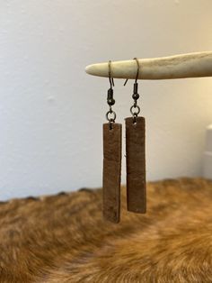 This gorgeous pair of earrings is crafted from authentic leather full of natural texture and character. Medium brown color leather, aged bronze tone hardware, nickel-free. Leather bar is 1.5 inches in length. Artisan Leather Nickel-free Earrings, Handmade Brown Earrings For Everyday Use, Brown Rectangular Earrings With Ear Wire, Handmade Minimalist Leather Earrings, Hand Tooled Brown Earrings For Everyday Wear, Brown Hand Tooled Everyday Earrings, Brown Leather Minimalist Earrings, Minimalist Brown Leather Earrings, Everyday Brown Jewelry With Waxed Finish