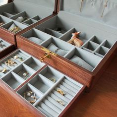 an open wooden box with jewelry in it