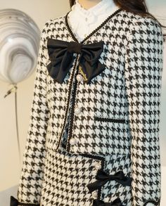 Features: It features v-neck with bowknot front, long sleeves, heart-shaped patches on the cuffs, placket with four pearl buttons, short jacket. High waist, A-line short skirt.  Attention: This price includes a jacket or a skirt only, others are not included.   Size Chart of Jacket:  Size (CM): Unit CM; Sizes below are measured in flat-laid position, hand measurement will have discrepancy of about 2 CM.   	 		 			Size(cm) 			S 			M 			L 			XL 			XXL 		 		 			Bust 			90 			94 			98 			106 			110 Fall Party Outerwear With Bow, Elegant Bow Outerwear For Spring, Elegant Spring Outerwear With Bow, Elegant Long Sleeve Outerwear With Bow, Lover Black And White, Skirt Straight, Checkered Jacket, Elegant Jacket, Plaid Ribbon