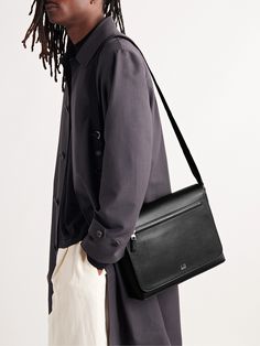 Having easy access to your goods and chattels can be a lifesaver, and Dunhill's design team gets it. Made in Italy, this full-grain leather 'Cadogan' messenger bag features an adjustable shoulder strap, an open compartment with two pockets and magnetic flap closure at the front. Designer Saddle Bag For Business, Designer Smooth Grain Shoulder Bag For Business, Black Saffiano Leather Shoulder Bag With Smooth Grain, Timeless Business Flap Bag With Smooth Grain, Timeless Smooth Grain Flap Bag For Business, Designer Leather Flap Bag For Business, Designer Saddle Bag With Leather Lining For Travel, Designer Soft Leather Flap Bag For Business, Designer Crossbody Saddle Bag For Business