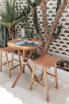 two wooden stools sitting next to a small table