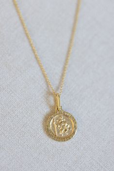 The protection and guidance of Saint Christopher, the patron saint of travelers, in our 14k gold vermeil necklace, beautifully made to accompany you to all of your favorite destinations. Spiritual 14k Gold Charm Necklaces With Coin Pendant, Spiritual 14k Gold Filled Yellow Gold Charm Necklaces, Spiritual Yellow Gold Sterling Silver Coin Necklace, Spiritual 14k Gold Coin Pendant Necklace, Spiritual 14k Gold-filled Yellow Gold Charm Necklace, Spiritual Sterling Silver Coin Necklace In Yellow Gold, Spiritual Yellow Gold Coin Necklace, Spiritual Yellow Gold Medallion Charm Necklace, 14k Gold Spiritual Coin Necklace