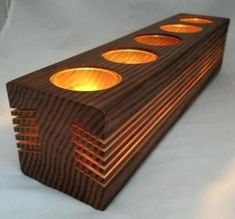 a wooden object with four holes on it's side and three lights in the middle