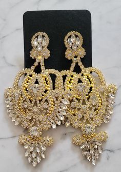 Dainty girls...keep scrolling! These Sasha Chandelier Earrings are large, fierce and of course very GLAM. Dripping in clear or champagne colored stones, these statement earrings are gorgeous enough for some evening time or holiday glam look, and versatile enough to Glam up your daytime looks. ** gold w/ gold available as preorder to be shipped week of 12/12 ** Jewelry 101, Evening Time, Glam Earrings, Large Statement Earrings, Gold Chandelier Earrings, Engagement Proposal, Holiday Glam, Gold Pendant Jewelry, Class Reunion