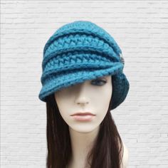 This womans winter hat is inspired by the flapper style hats of the 1920s. It is hand crocheted with soft wool blend yarn in teal.  The bottom of the hat flares out slightly and the gathering has glass hand-beaded knot detail in brushed silver glass beads.  Hat Sizing small: 20-21in / 50-54cm medium: 22-23in / 55-60cm  large: 24-25in / 61-64cm custom: for head measurements outside standard sizing please contact me for adjusted pricing.  ~~Kids sizes available. Vintage Hand Knitted Crochet Hat For Winter, Vintage Hand-knitted Crochet Winter Hat, Brimmed Yarn Cloche Hat For Winter, Yarn Brimmed Cloche Hat For Winter, Winter Yarn Brimmed Cloche Hat, Winter Yarn Cloche Hat With Brim, Adjustable Hand Knitted Cloche Hat For Winter, Hand Knitted Adjustable Cloche Hat For Winter, Vintage Winter Crochet Hat