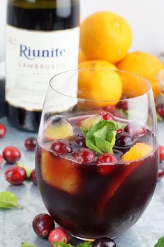 a close up of a wine glass with fruit in it