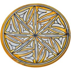 a yellow and white plate with designs on it