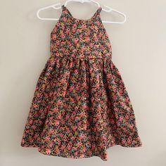 Ready to ship! Size 3T tie-back dress in a whimsical Rifle Paper Co hot pink and metallic gold floral rosa print on a burgundy background. Featuring an adorable adjustable tie back, high neckline, and elastic back waist. Hits knee length and fits true to size. Full gathered skirt for maximum twirl potential. Stay cool all summer, then layer over long sleeves or with tights and a sweater for fall! Handmade in Michigan from 100% cotton. Cute Floral Print Sundress For Dress-up, Summer Floral Print Dress For Dress-up, Fitted Floral Print Twirl Dress For Summer, Floral Print Dress For Summer Dress-up, Cute Fitted Floral Print Twirl Dress, Pink Cotton Sundress, Pink Cotton Sundress For Casual Wear, Cute Sleeveless Floral Twirl Dress, Sleeveless Summer Floral Dress For Dress-up