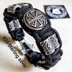 Black Viking protective amulet. Luxury gift for biker. Runic paracord bracelet.925 Sterling silver runes. Viking jewelry.Stylish handmade paracord bracelets for those who are always moving forward. These fashion accessories are made of extremely durable, scratch-resistant rope and original 925 Sterling silver beads runes.This bracelet contains 58 grams of pure 925 sterling silver. The castle weighs 14.74 grams, the 8 runes beads weighs 36 grams, and 1 round bead "KOLOVRAT" (black sun) weigh 8 gr Black Viking Jewelry For Outdoor, Black Viking Style Jewelry For Outdoor, Black Viking Style Outdoor Jewelry, Black Symbolic Engraved Bracelets, Symbolic Black Engraved Bracelets, Handmade Viking Style Black Bracelet, Adjustable Silver Paracord Bracelets, Handmade Black Braided Bracelets For Outdoor, Handmade Black Sterling Silver Braided Bracelet