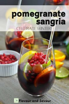 two glasses filled with sanga and garnished with pomegranates