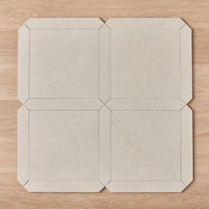 four pieces of paper laid out on top of a wooden table