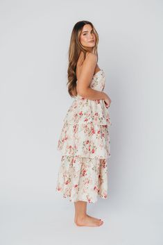 Look no further for that special event dress you've been hunting - the Britney Midi Dress is here to save the day (and make you the belle of the ball). This stunning floral eyelet print dress features a bustier-style bodice with a sweetheart neckline, paired with a multi-tiered skirt and flows beautifully with every movement. Pair this gem with heeled sandals or pumps and make your next event very special indeed! FIT: Runs true to size. Bodice is very fitted; fabric does not stretch. MATERIAL: Hand wash cold, do not bleach. Line dry, do not tumble dry. Iron low if needed. GARMENT DETAILS: Strapless midi dress in a floral eyelet fabric. Features a fitted, bustier-style bodice with sweetheart neckline, paired with a full, multi-tiered skirt with flounces. SIZE GUIDE: S (2-4) / M (6-8) / L (1 Floral Print Strapless Dress With Sweetheart Neckline, Spring Strapless Dress With Corset Back, Strapless Spring Dress With Corset Back, Strapless Dress With Corset Back For Spring, Strapless Ruffled Midi Dress For Garden Party, Spring Midi Corset Dress With Ruffles, Spring Brunch Dress With Lined Bodice, Spring Dress With Boned Bodice And Spaghetti Straps, Spring Tiered Dress With Ruched Bodice