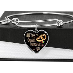 a heart shaped bracelet with the words 30 years down forever to go