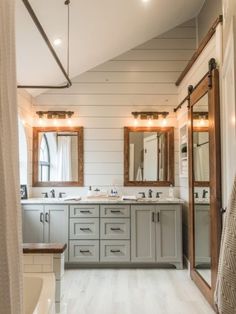 a large bathroom with double sinks and mirrors