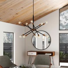 a dining room table with chairs and a round mirror