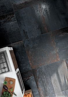 an overhead view of a kitchen with black tile flooring