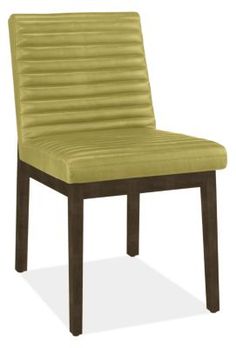 an upholstered chair with wooden legs and a green fabric seat pad on the back