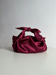 Small satin bag with knots. Stylish small handmade bag that is suitable for any event. Bag with bows is soft, closes with a magnetic button. Burgundy bow bag is made in a vintage style based on the Japanese technique of tying a silk women's scarf into a handbag. Elegant small woman bag is very roomy - fits a phone, wallet, keys, makeup. Perfect wedding purse. The handbag can be sewn from satin or velvet. I have a huge selection of colors, more than indicated in the listing. Please write me the desired color and I will try to make your dream handbag a reality. I'm always in touch. The size of furoshiki knot bag: Height 20cm Width 30cm (7" * 12") *since the handbag is soft and does not hold a specific shape, the size is indicated approximately Material: Soft, pleasant to the touch satin with Elegant Bag With Detachable Bow As Gift, Elegant Bag With Detachable Bow For Gift, Satin Bags With Satin Finish For Events, Clutch Bag With Bow For Events, Bow Clutch Bag For Gift, Elegant Bags With Decorative Bow, Event Clutch Bag With Bow Detail, Gift Clutch Bag With Bow, Event Clutch Bags With Bow Detail