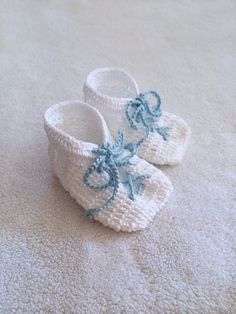 Hand Knit Baby Booties Gift - White - Baby Blue Lace Up Detail - Baby shower gift - Baby gift - Nursery decor - Newborn baby knit bootiesBecause baby boys need adorable knit booties too!These have a cool lace up front that are sure to make your little man stand out anywhere.They feature a square toe, and are bootie style.Baby can wear these with or without socks as they are made out of a gentle cotton yarn.  They can also make for a very cute keepsake.Having Boy/Girl Twins?  These have the perfe Boy Girl Twins, Knit Baby Booties, Knitted Booties, Crib Shoes, Baby Booties, Blue Lace, Baby Shower Gift, Boy Girl, Baby Gift