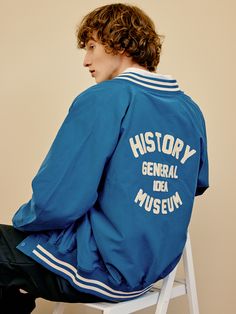 Editor's notesIt is a casual stadium jacket in polyester blend cotton fabric. The jacket features soft touch and semi-glossy texture. It has lettering graphic on the back and stripes on neck, cuffs, and hem. The colorblock point in classic mood and matte spring snap button add vintage and classic vibe.- Standard fit- Ribbed neck, cuffs, hem- Side pockets- Snap button closureMeasurements(in.)M / L- Center back to sleeve hem: 32.3 in. / 35.4 in.- Chest: 22.4 in. / 24.4 in.- Hem: 13.8 in. / 16.5 in Sporty Letter Print Windbreaker For Fall, Blue Outerwear With Letter Print For Sports Events, Varsity Windbreaker With Letter Print, Varsity Windbreaker With Letter Print Long Sleeves, Varsity Windbreaker With Baseball Collar, Varsity Windbreaker With Baseball Collar For Sports, College Long Sleeve Windbreaker With Letter Print, Long Sleeve Windbreaker With Letter Print For College, College Long-sleeved Windbreaker With Letter Print