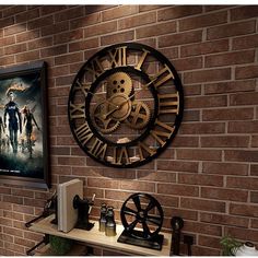 a large clock mounted to the side of a brick wall next to a movie poster