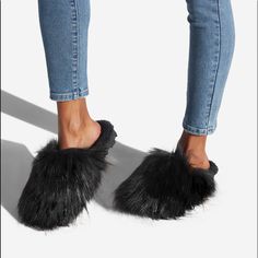 A Cozy Slip-On Fuzzie With A Faux-Fur Lining. Material: Textile Features: Memory Foam Padding For Added Comfort Outside Heel Height: 0.5" Imported Black Faux Fur Slippers For Winter, Winter Faux Fur Slippers With Scuffs, Casual Faux Fur Slippers For Winter, Faux Fur Slippers With Round Toe For Fall, Casual Winter Slippers With Faux Fur Lining, Winter Faux Fur Flat Slippers, Casual Faux Fur Slip-on Slippers, Casual Soft Faux Fur Slippers, Fall Faux Fur Lined Slippers