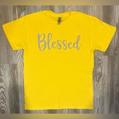 Yellow Shirt, Silver Glitter Letters, Brand New, Never Worn Made By Angel Tymes, Llc Gold Letter Print Top For Summer, Gold Letter Print Tops For Summer, Gold Short Sleeve Tops With Glitter Print, Gold Short Sleeve Top With Glitter Print, Blessed Shirt, Glitter Letters, Yellow Shirt, Yellow Shirts, Silver Glitter