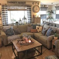 a living room filled with lots of furniture and decor on top of a wooden table