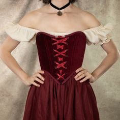 Our dark red velvet corset is the ultimate statement piece for those seeking a blend of luxurious elegance and historical charm. Perfect for renaissance faire costumes, Christmas parties, gothic or vampire outfits, or simply adding a bold, regal touch to your wardrobe, this corset is designed to flatter your silhouette while offering comfort and durability. Crafted from rich, 100% cotton deep red velvet, this corset features a classic lace-up front and back lacing for an adjustable fit, and synt Velvet Corset Dress For Costume Party, Red Vintage Fitted Medieval Dress, Red Fitted Vintage Medieval Dress, Fitted Red Vintage Medieval Dress, Vampire Style Overbust Corset Dress, Vintage Red Fitted Medieval Dress, Medieval Bodice For Costume Party, Medieval Fitted Bodice For Costume Party, Fitted Medieval Bodice For Costume Party