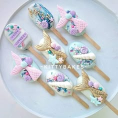 there are some little mermaid lollipops on the stick