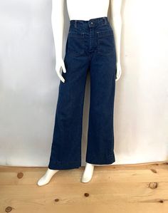 Vintage 70's Wide Leg Bell Bottom Jeans (Size 4/6) These 70's Ladies Jeans come in a light to medium blue cotton two large pockets with pleat detail, and are high waisted, with a front metal zipper, a single snap button closure, and wide, bell bottom leg shape. The cotton is light weight (similar to a pant) and have very light stretch. 100% Cotton *These jeans are in excellent condition with fading on the back (photo #10) *Free shipping within the US, and will go Priority Mail for a quick delivery! Size: (S/M) Modern Day 4/6 Waist: 24"-26" (back elastic waist) Hips: 36" Inseam: 29 1/2" (can let out 3") Rise: 12 1/2" (front) 14" (back) Bell Bottom Width: 11 1/2" Weight: 1 pound 5 oz *Follow Freshandswanky on Instagram Back Photo, Ladies Jeans, Jean Vintage, Bottom Jeans, Womens Jeans, Bell Bottom, Medium Blue, Snap Button, Vintage 70s