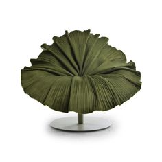 a large green leaf shaped object on a metal stand