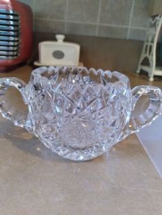 a glass cup sitting on top of a counter