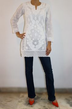 Experience timeless elegance with our white cotton kurta, adorned with exquisite vintage chikankari embroidery. Featuring a chic split neckline, side panels, and side slits, this piece is both stylish and comfortable. The handmade crochet detailing on the hem and sleeves adds a touch of artisanal charm, making it a perfect blend of tradition and contemporary fashion. lenght - 31/32 inches Sizes  -  XS - fits bust 32 S - fits bust 34 M - fits bust 36 L - fits bust 38 XL - fits bust 40 0X - fits bust 42 1X - fits bust 44 Prewashed. Preshrunk. White Tunic With Chikankari Embroidery, White Tunic With Resham Embroidery, White Chikankari Embroidered Tunic, White Resham Embroidered Tunic, White Resham Embroidery Tunic, White Long Sleeve Tunic With Chikankari Embroidery, White Long Sleeve Chikankari Tunic, Elegant White Tunic With Floral Embroidery, Elegant Chikankari Embroidery Tunic