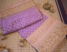 A Lovely Lavender Pure Banarasi Georgette Gota Embroidered Saree in a fabulous pattern. The saree is adorned with intricate gota patti handwork which makes it all the more a perfect choice for occasion wear. Its a fusion of karigari from Banaras and Rajasthan. We must say, a truely heirloom piece. The zari work on the saree is done in Banaras. Then the karigars of Rajasthan have worked their magic with the gota embroidery. So its takes about a couple of months for a single saree to be ready. Add Traditional Lavender Lehenga Designer Wear, Lavender Traditional Wear For Wedding And Festive Occasions, Festive Lavender Traditional Wear For Wedding, Traditional Lavender Lehenga With Resham Embroidery, Lavender Resham Embroidery Saree For Wedding, Lavender Dupatta With Pallu For Wedding, Lavender Saree With Resham Embroidery For Wedding, Lavender Traditional Wear With Zari Work For Wedding, Traditional Lavender Lehenga With Traditional Drape