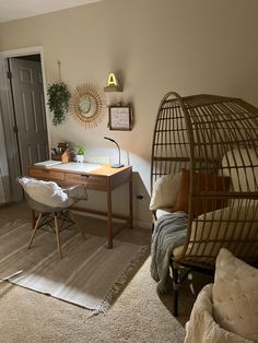 a bedroom with a bed, desk and birdcage