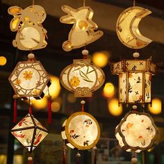 an assortment of chinese lanterns hanging from the ceiling