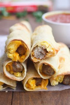 breakfast burritos with eggs, sausage and cheese are ready to be served in the oven