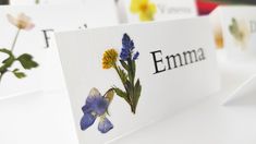 flowers are placed on cards with the word emma