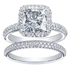 an engagement ring set with a princess cut diamond in the center and two rows of pave