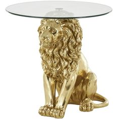 a golden lion sitting under a glass table